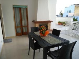 a black table with chairs and a vase of flowers at Josephine Holidays in Lecce