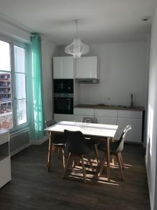 a kitchen with a table and chairs in a room at Cannes la bocca appartement in Cannes