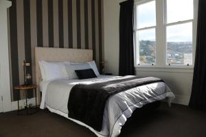 A bed or beds in a room at Majestic Mansions – Apartments at St Clair