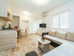 a living room with a couch and a table at Apartments Fillip in Petrovac na Moru