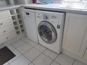 a washing machine in a kitchen with a counter at 3 bed room house in Aberdeen