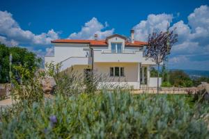 a white house with a red roof at Villa Iva Grubine - near Makarska (Split County) in Grubine