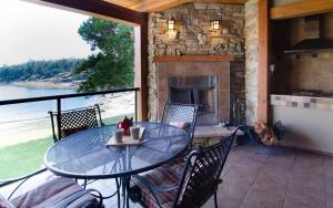 a patio with a table and chairs and a fireplace at Galiano Oceanfront Inn & Spa in Galiano