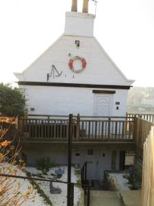 a church with a red wreath on the side of it at Esk Cottage - Cyanacottages in Whitby