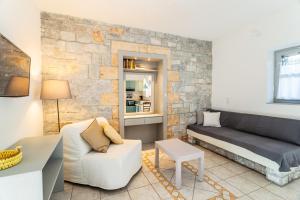 a living room with a couch and a table at Electra Houses in Stoupa