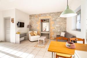 a kitchen and living room with a brick wall at Electra Houses in Stoupa