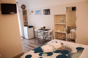 a small room with a table and a small kitchen at Welcome Dimora in Polignano a Mare