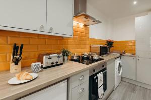 a kitchen with a counter with a plate of bread on it at Halifax House, Studio Apartment 215 in Halifax