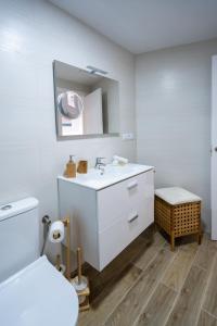 a white bathroom with a sink and a mirror at ✪dona Apartment in Las Palmas de Gran Canaria