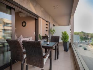 an apartment balcony with a table and chairs on it at Onyx City Center Apartment in Heraklio