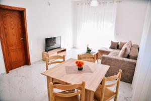 a living room with a table and a couch at Riva Luxury in Ulcinj