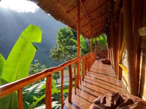 a balcony of a house with a view of trees at Mount Wood Star in Ella