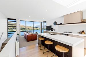 a kitchen and living room with a view of the water at Peak View Residence in Queenstown +9 photos