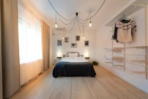 a bedroom with a bed and a wall with shelves at Antic Apartments in Bucharest