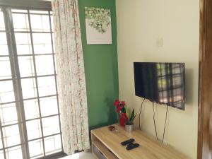 a living room with a flat screen tv next to a window at GVR Homestay 3 in Genting Highlands