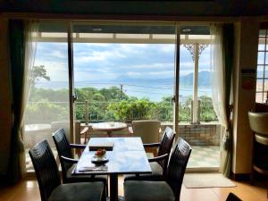 a dining room with a table and chairs and a large window at Villa High Wharf in Wanli