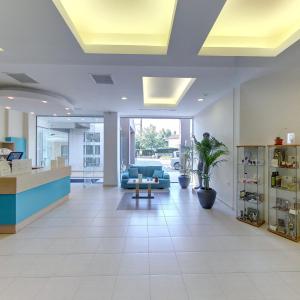 an office lobby with a couch and a table at Cronwell Platamon Resort All-Inclusive in Platamonas +67 photos