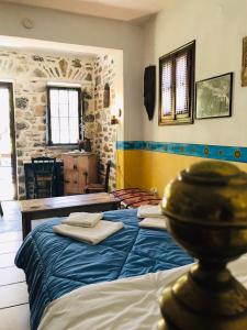a bedroom with two beds with towels on them at Damouchari Hotel in Damouchari