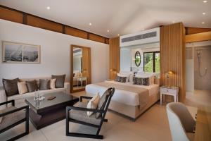 a bedroom with a bed and a living room at The Setai Sea Of Galilee in Ein Gev