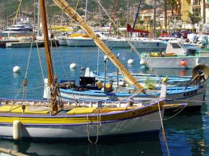 a sail boat docked in a harbor with other boats at Grand Hôtel De Calvi in Calvi