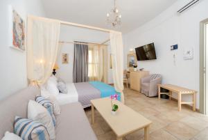 a hotel room with a bed and a couch at Hotel Mathios in Akrotiri