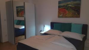a bedroom with a bed and a large mirror at Appartment Cerny in Eisenstadt