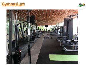 a gym with a lot of treadms and machines at Hassan Ashok in Hassan