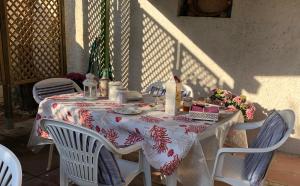 a table with a red and white table cloth at La Lantana Nuova in Flumini di Quartu