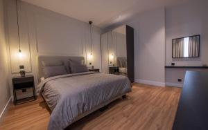 a bedroom with a large bed and a large mirror at Monaco Central 1 bedroom appartement in Beausoleil