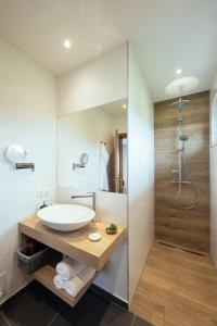 a bathroom with a sink and a shower at Pension Auszeit Velden in Velden am Wörthersee