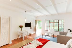 a living room with a couch and a table at Albourne Guesthouse in Somerset West