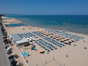 an aerial view of a beach with umbrellas and the ocean at Verdemare in Torino di Sangro
