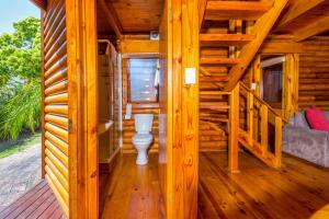 a wooden cabin with a toilet on a deck at Abalone Lodges in Knysna
