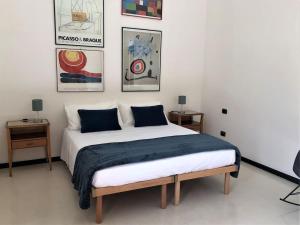 a bedroom with a large bed with two tables at ARDUINO AL TRE in Alghero