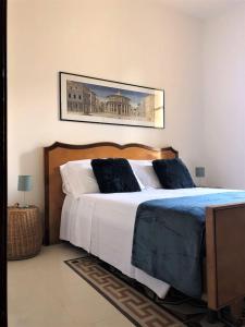 a bedroom with a large bed and a picture on the wall at ARDUINO AL TRE in Alghero