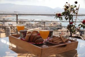 a tray of food and two glasses of orange juice at Piraeus Lux Secret in Piraeus