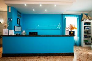 a blue wall in a room with a counter at Delfino in Marina di Camerota