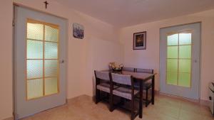 a dining room with a table and chairs at Zacisze in Hołuczków +15 photos