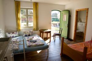 a living room with a couch and a table at Mirabellenhof- Remise in Biesenthal