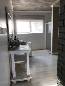 a room with a table in the middle of a room at The Vineyard East in Joostenberg Vlakte +6 photos