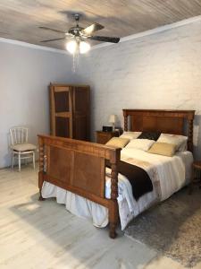 a bedroom with a bed and a ceiling fan at The Vineyard East in Joostenberg Vlakte