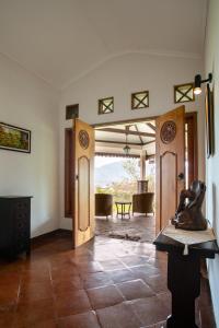 a living room with two doors and a table at Shanty's House in Batu