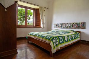 a bedroom with a bed and a window at Shanty's House in Batu