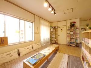 a living room with a couch and a table at Greenday Guesthouse in Jeju