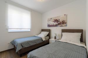Postel nebo postele na pokoji v ubytování Luxury Apartman Ivana
