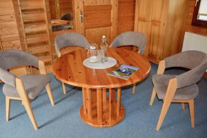 a wooden table and chairs in a room at Blockhaus in Gnarrenburg