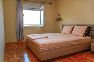 a small bedroom with a bed with a window at Ana in Budva