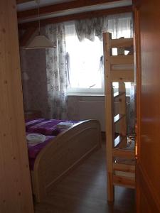 a bedroom with a bunk bed and a window at Pension-Stürrad in Neuharlingersiel