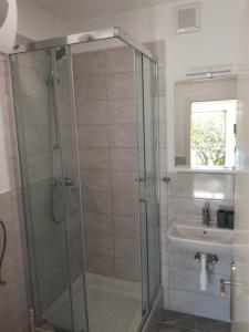 a bathroom with a shower and a sink at Adrian's Apartments & Winery in Lumbarda