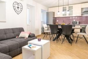 a living room with a couch and a table at Apartment Laura in Dubrovnik